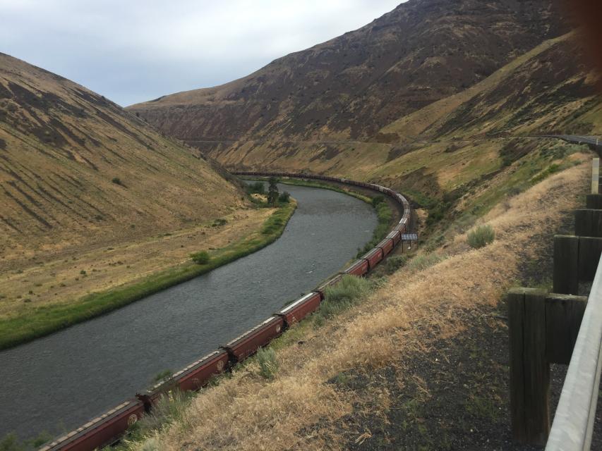 Train by the river in the canyon